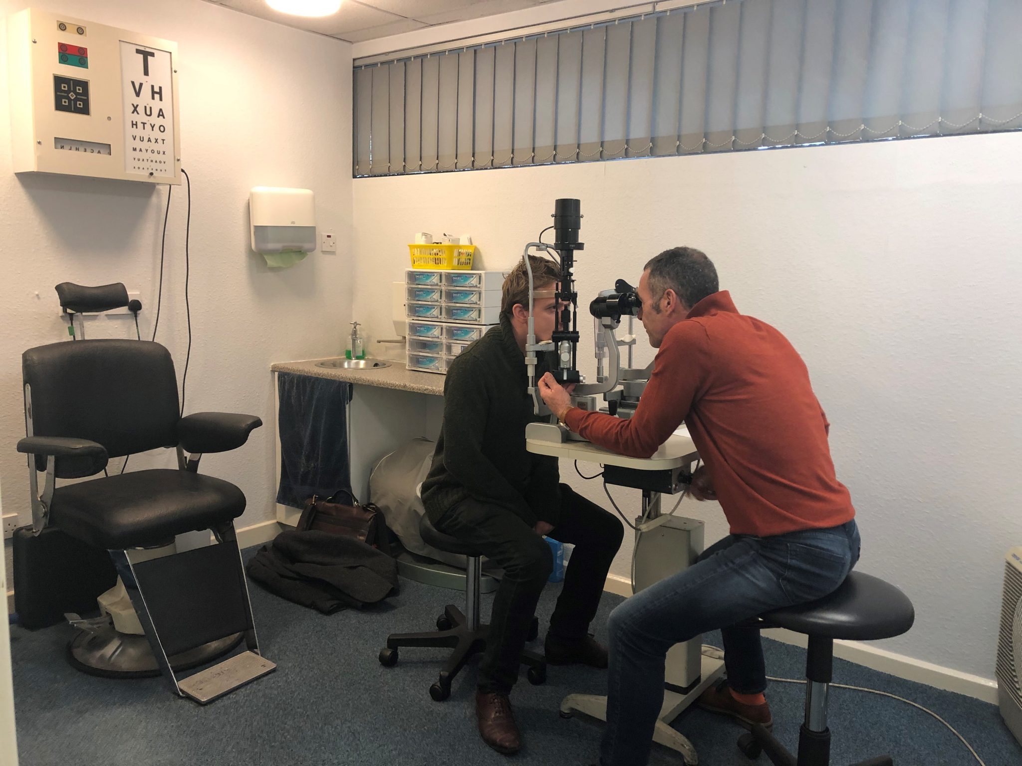 Optician Chris Checking Patients eye during a contact lense fitting in Barnsely